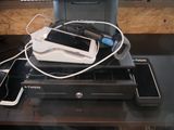a printer, cell phone, and printer on a desk
