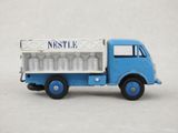 a blue toy truck with a nestle sign on the back