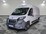 the white van is parked in a large room with a checkered floor
