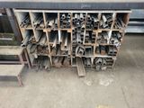 a pile of metal pipes and tubes in a warehouse