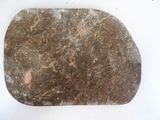 a stone with a design on it sitting on a white surface