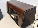 a brown radio sitting on a table next to a laptop