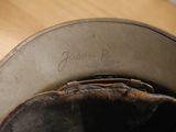 a close up of a baseball glove in a hat on a table