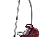 a red vacuum cleaner with a hose and a hose attached to it