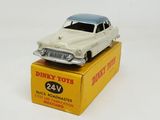 a toy car on top of a box on a white surface