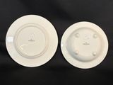 two white plates sitting on top of a black table