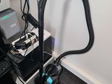 a vacuum that is sitting on a desk next to a laptop