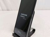 a black samsung galaxy s9 phone sitting on top of a stand