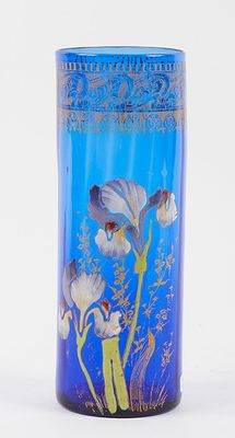 a blue vase with flowers on it on a white surface