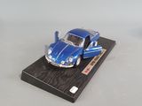 a small blue car on a small black platform