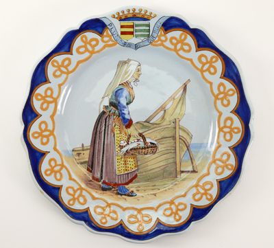 a plate with a picture of a woman sitting on a boat