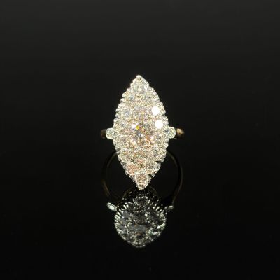 a close up of a diamond ring on a black surface