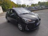 the toyota ay is parked on the side of the road in a parking lot