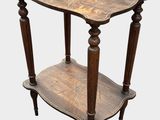an old wooden table with a shelf on top of it