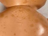 a close up of a brown vase with a label on it