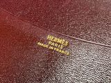 the inside of a red leather purse with a gold logo on it