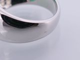 a close up of a ring on a white surface