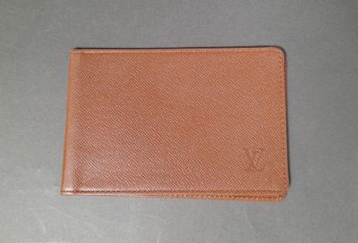 a brown leather wallet sitting on top of a table
