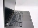 a silver laptop with a black keyboard on a white surface