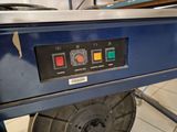 an image of a machine that is working on a piece of metal