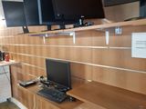 many monitors on the shelves in the room