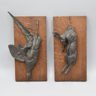 pair of bronze birds mounted on wood blocks on a white background