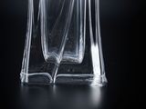 an image of a glass bottle of perfume on a black background