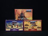 three boxes of action figures on a black surface