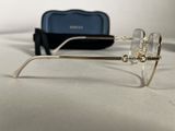 a pair of glasses sitting on a table next to a pair of glasses