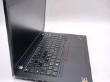 a black laptop with a red button on the keyboard