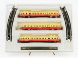 three trains that are sitting in a display case