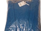 the blue blanket is wrapped in plastic and ready to be used