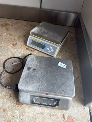 two scales sitting on the floor next to each other