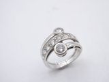 a close up of a ring with diamonds on a white surface