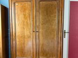 a wooden armoire in the corner of a room
