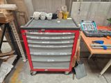 a red tool cabinet with tools on top of it