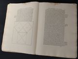 an open book with a drawing of a square on it