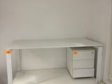 a white desk with a computer on it in a room