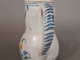 a white vase with a blue and white design on it