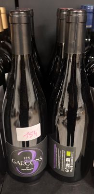 several bottles of wine are on a shelf in a store