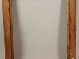 an old wooden frame with a white background and a white wall
