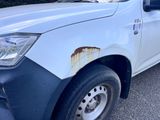 a picture of a white truck with rust on the side of it