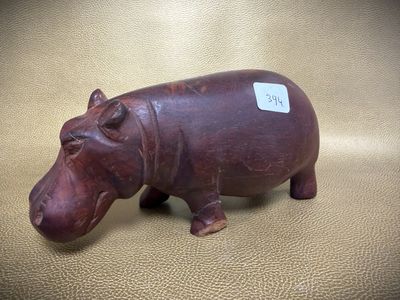 a figurine of a hippo with a tag on it