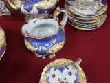 de nombreux types de théières et de soucoupes sur la table
