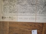 two maps on a table with a piece of paper next to them