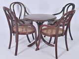 three chairs and a table in a room