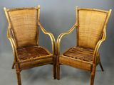 pair of wicker chairs with cane backrests