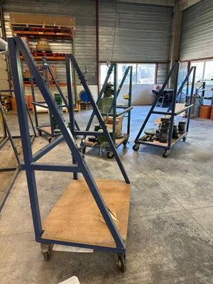 a dolly cart in the middle of a room with a ladder