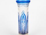 a blue and white vase sitting on a silver stand