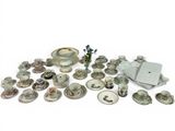 many different types of dishes and cups on the table